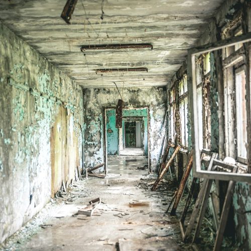 ruined class room with desks and blackboards in Pripyat school